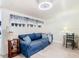 Bright home office with hardwood floors, comfy couch, and built-in desk at 1447 Santa Anna Dr, Dunedin, FL 34698