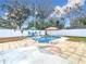 Inviting pool area with patio and colorful umbrella at 1447 Santa Anna Dr, Dunedin, FL 34698