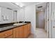 Bathroom with granite countertop, wood cabinets, and shower at 17940 Gulf Blvd # 15C, Redington Shores, FL 33708