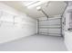 Garage with overhead door and ample storage shelving at 21548 Clubside Loop, Lutz, FL 33549