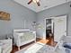 Bright Bedroom features a crib, armchair, and ample storage at 2309 Cross Tee Ct, Brooksville, FL 34604