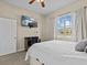 Bedroom with queen bed, large window, and workspace at 2309 Cross Tee Ct, Brooksville, FL 34604