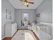 Bedroom with a crib, changing table, and plenty of natural light at 2309 Cross Tee Ct, Brooksville, FL 34604
