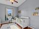 Bedroom with crib, chair, and window with natural light at 2309 Cross Tee Ct, Brooksville, FL 34604