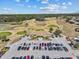 Aerial view of a clubhouse with a full parking lot, indicating a potentially active community at 2309 Cross Tee Ct, Brooksville, FL 34604