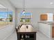 Casual dining area with wood table and view of backyard at 2309 Cross Tee Ct, Brooksville, FL 34604