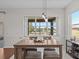 Bright dining area with wood table, water view, and pendant lights at 2309 Cross Tee Ct, Brooksville, FL 34604