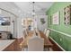 Bright dining room features a wood table, neutral chairs, and an accent wall at 2309 Cross Tee Ct, Brooksville, FL 34604