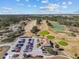 Aerial view of a golf course with clubhouse and parking lot at 2309 Cross Tee Ct, Brooksville, FL 34604