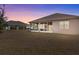 House exterior showcasing a screened patio and backyard at 2309 Cross Tee Ct, Brooksville, FL 34604