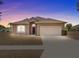 One-story tan house with a two-car garage and well-maintained lawn at 2309 Cross Tee Ct, Brooksville, FL 34604