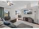 Spacious living room with gray sectional sofa and view of backyard at 2309 Cross Tee Ct, Brooksville, FL 34604