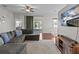 Relaxing living room with gray sectional, large TV, and access to patio at 2309 Cross Tee Ct, Brooksville, FL 34604
