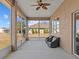 Screened porch with ceiling fan and comfortable seating at 2309 Cross Tee Ct, Brooksville, FL 34604