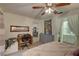 Bedroom with a desk workspace, dresser, and view into the bathroom at 2579 Bay Berry Dr # 42D, Clearwater, FL 33763