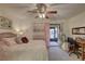 Main bedroom with a ceiling fan, queen bed, and access to a private patio at 2579 Bay Berry Dr # 42D, Clearwater, FL 33763