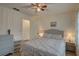 Bedroom with a queen bed, ceiling fan, and dresser with storage at 2579 Bay Berry Dr # 42D, Clearwater, FL 33763
