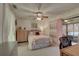 Spacious bedroom with a ceiling fan, plush bedding, and access to a patio at 2579 Bay Berry Dr # 42D, Clearwater, FL 33763