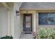 Front door entry with a screen door and a hanging planter at 2579 Bay Berry Dr # 42D, Clearwater, FL 33763