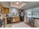 Bright kitchen features wood cabinets, black appliances, and a breakfast bar at 2579 Bay Berry Dr # 42D, Clearwater, FL 33763