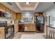 Well-equipped kitchen featuring wood cabinets and black appliances at 2579 Bay Berry Dr # 42D, Clearwater, FL 33763
