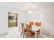 Dining area with wood table and chairs, kitchen view at 2700 Bayshore Blvd # 1305, Dunedin, FL 34698