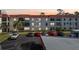 Exterior view of condo building with parking lot in front at 2700 Bayshore Blvd # 1305, Dunedin, FL 34698
