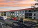 Building exterior showcasing ample parking and beautiful sunset views at 2700 Bayshore Blvd # 1305, Dunedin, FL 34698