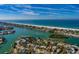 Coastal aerial view of home and neighborhood with water access and beaches at 3110 W De Bazan Ave, St Pete Beach, FL 33706