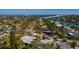 Beautiful home surrounded by mature trees and landscaping near the water, showcasing its prime location at 3110 W De Bazan Ave, St Pete Beach, FL 33706