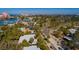 A high-angle captures a serene neighborhood with its charming homes, palm trees, and glimpses of the waterway at 3110 W De Bazan Ave, St Pete Beach, FL 33706