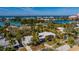 This stunning aerial view of the residence shows lush landscaping and proximity to the bay at 3110 W De Bazan Ave, St Pete Beach, FL 33706