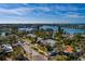 Aerial view of home with lush landscaping and ample street parking near a scenic waterfront at 3110 W De Bazan Ave, St Pete Beach, FL 33706