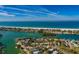 Breathtaking aerial view showcases the home near pristine blue waters and white sandy beaches at 3110 W De Bazan Ave, St Pete Beach, FL 33706