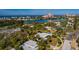 A high-angle captures a serene neighborhood with its charming homes, palm trees, and glimpses of the waterway at 3110 W De Bazan Ave, St Pete Beach, FL 33706