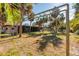 Property showcases a spacious backyard with mature palm trees, offering ample space for outdoor activities and relaxation at 3110 W De Bazan Ave, St Pete Beach, FL 33706