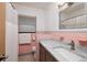 Bathroom features a marble countertop, and a tile shower with matching pink tile at 3110 W De Bazan Ave, St Pete Beach, FL 33706