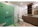Bathroom featuring a glass enclosed shower, tile flooring, and a modern vanity at 3110 W De Bazan Ave, St Pete Beach, FL 33706