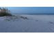 Twilight scenery of sandy beach with calm water and light skies at 3110 W De Bazan Ave, St Pete Beach, FL 33706