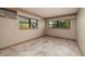 Well-lit bedroom features tile flooring and windows offering views of the outdoors at 3110 W De Bazan Ave, St Pete Beach, FL 33706