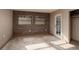 Bright bedroom features tile floors, natural light from two windows, and a door that leads to the outside at 3110 W De Bazan Ave, St Pete Beach, FL 33706