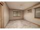 Bedroom featuring tile floor, ceiling fan, window, and closet with louvered doors at 3110 W De Bazan Ave, St Pete Beach, FL 33706