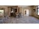 Open floorplan with bar top, tile flooring, seamlessly connecting the kitchen to the dining area at 3110 W De Bazan Ave, St Pete Beach, FL 33706