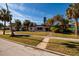 Charming single-story home features a well-manicured lawn and mature palm trees, enhancing its curb appeal at 3110 W De Bazan Ave, St Pete Beach, FL 33706