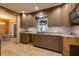 Updated kitchen features granite counters, modern cabinetry, tiled backsplash and stainless steel microwave at 3110 W De Bazan Ave, St Pete Beach, FL 33706