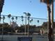 Community tennis court with palm trees, resort and a clear blue sky at 3110 W De Bazan Ave, St Pete Beach, FL 33706