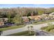 Aerial view of community, showing villas, roads, and mature trees at 3185 Charter Club Dr # A, Tarpon Springs, FL 34688
