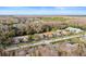 Aerial view showcasing villas, landscaping, and surrounding natural areas at 3185 Charter Club Dr # A, Tarpon Springs, FL 34688