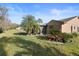Landscaped backyard with patio and lush greenery at 3185 Charter Club Dr # A, Tarpon Springs, FL 34688