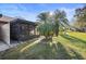 Private backyard with screened patio and palm trees at 3185 Charter Club Dr # A, Tarpon Springs, FL 34688